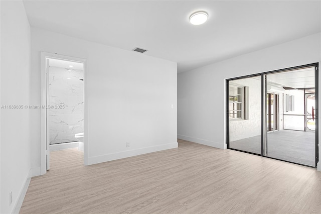 empty room with light hardwood / wood-style flooring