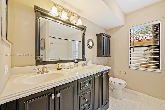 bathroom with tile patterned flooring, vanity, and toilet