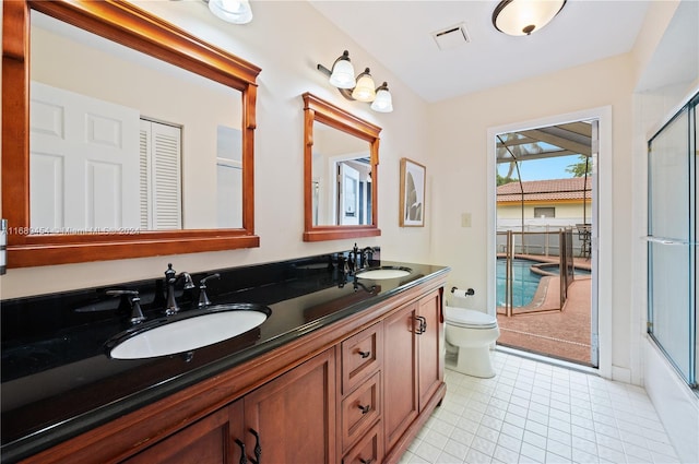 full bathroom with toilet, bath / shower combo with glass door, vanity, and tile patterned floors