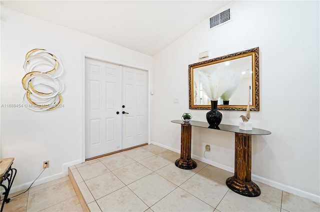 tiled foyer entrance with lofted ceiling