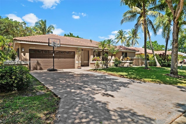 view of front of property with a garage and a front lawn