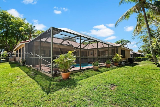 back of house with a yard, a fenced in pool, and glass enclosure