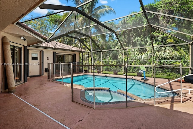 view of pool featuring a patio, a lanai, and an in ground hot tub