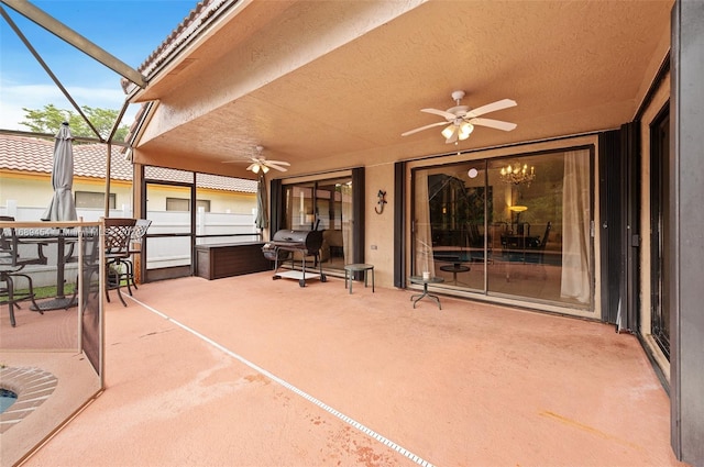 view of patio / terrace with ceiling fan and glass enclosure