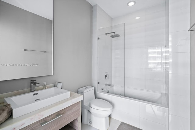 full bathroom with vanity, tile patterned floors, tiled shower / bath, and toilet