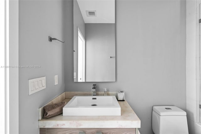 bathroom with vanity and toilet