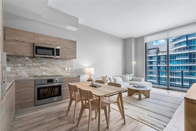 interior space featuring expansive windows and light hardwood / wood-style floors