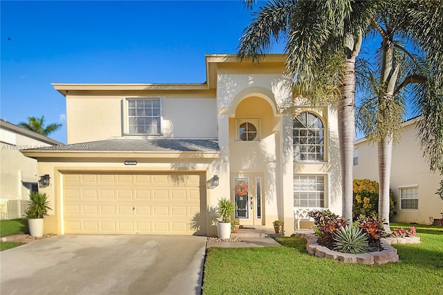 view of front of home featuring a garage and a front yard