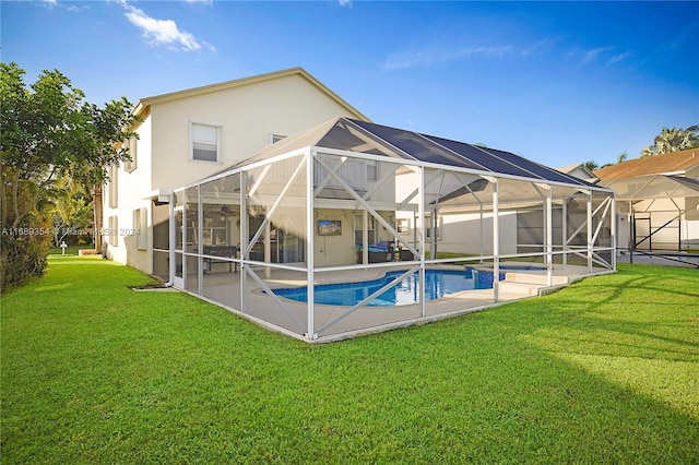 view of swimming pool with glass enclosure, a yard, and a patio area