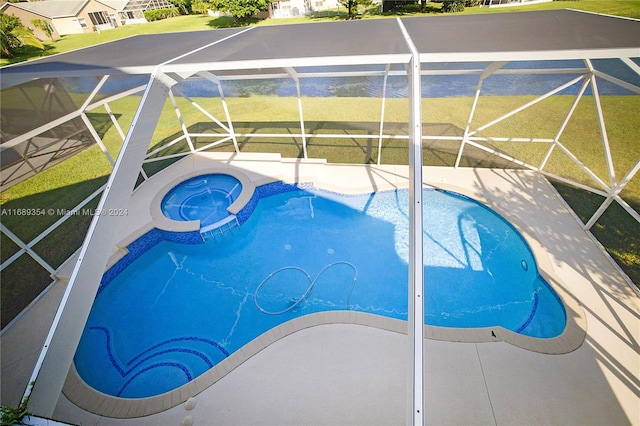 view of pool with glass enclosure, a patio area, and an in ground hot tub