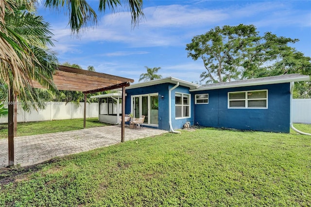 back of house with a pergola, a yard, and a patio area