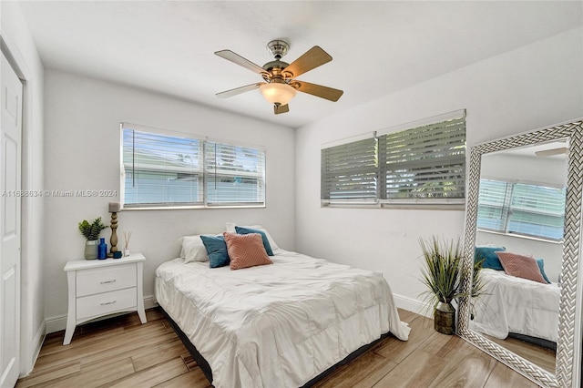 bedroom with ceiling fan and light wood-type flooring