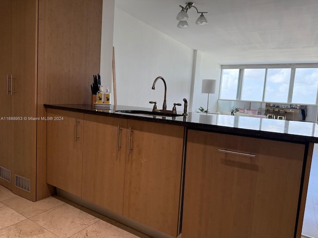 kitchen with dark stone counters and sink