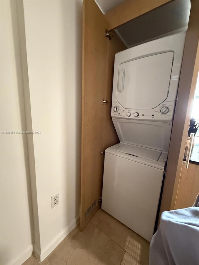 washroom with stacked washer / dryer