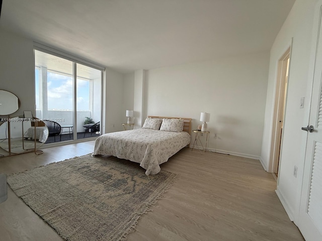 bedroom featuring access to outside and light hardwood / wood-style flooring