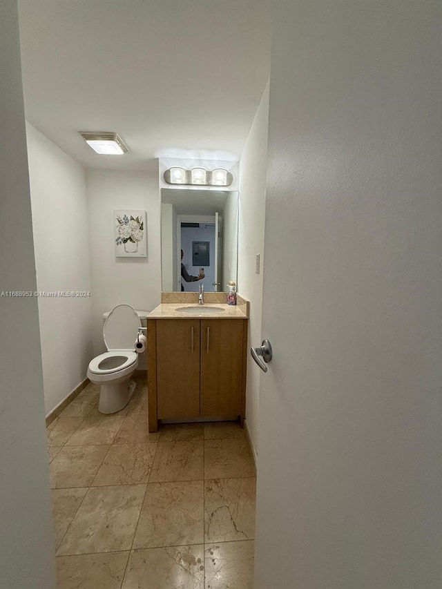 bathroom with toilet and vanity