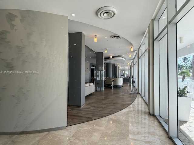 hallway with hardwood / wood-style floors