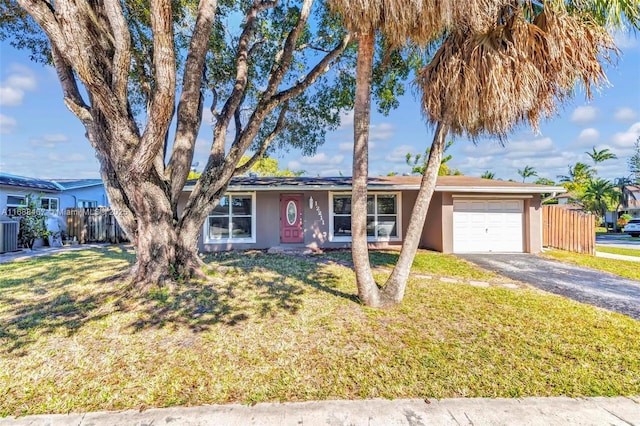 single story home with a garage, central air condition unit, and a front lawn