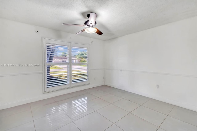 tiled spare room with ceiling fan and a textured ceiling