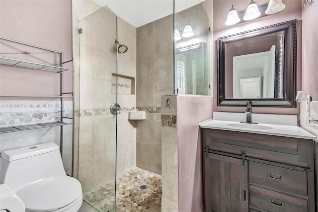 bathroom with vanity, toilet, and a shower with shower door