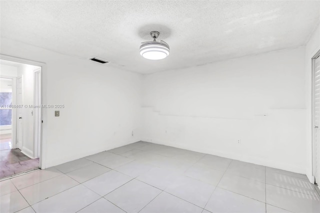 unfurnished room with a textured ceiling