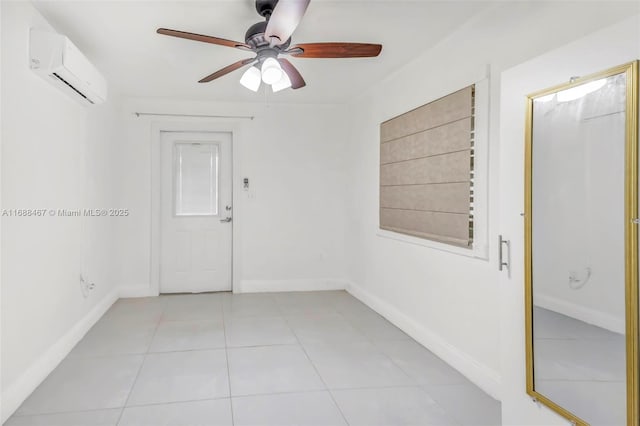 empty room featuring a wall mounted air conditioner, light tile patterned floors, and ceiling fan