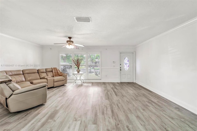 unfurnished living room featuring a textured ceiling, light wood-type flooring, ceiling fan, and ornamental molding