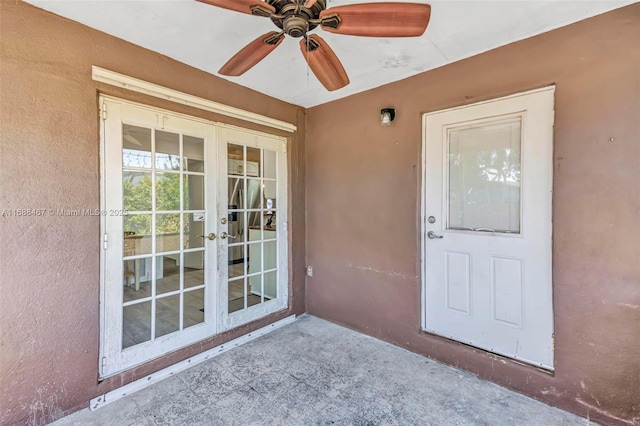 view of exterior entry featuring french doors and ceiling fan