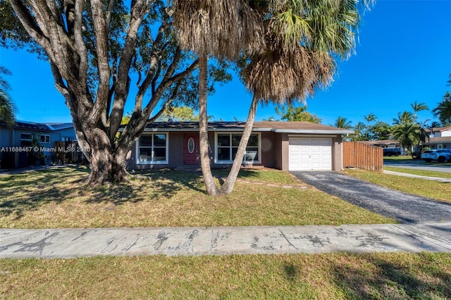 single story home featuring a front yard and a garage