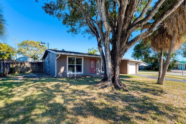 ranch-style home featuring a front lawn and a garage