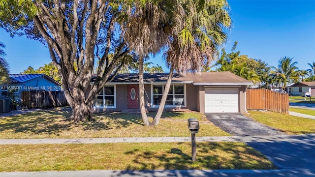 ranch-style home featuring a garage, a front yard, and central AC