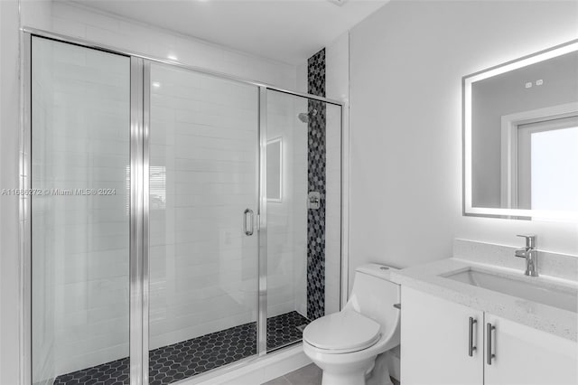 bathroom with walk in shower, vanity, and toilet