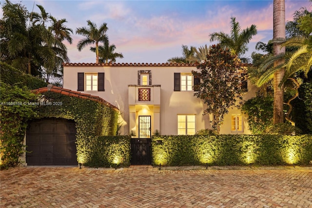 mediterranean / spanish home featuring a garage