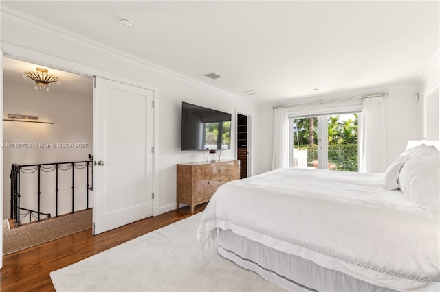 bedroom with dark hardwood / wood-style flooring and ornamental molding