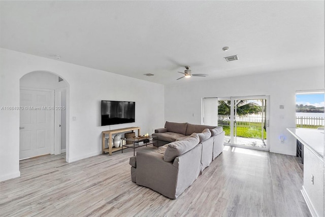 living room featuring ceiling fan and light hardwood / wood-style floors