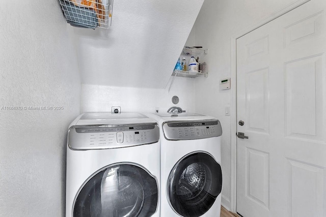 laundry area with washing machine and clothes dryer