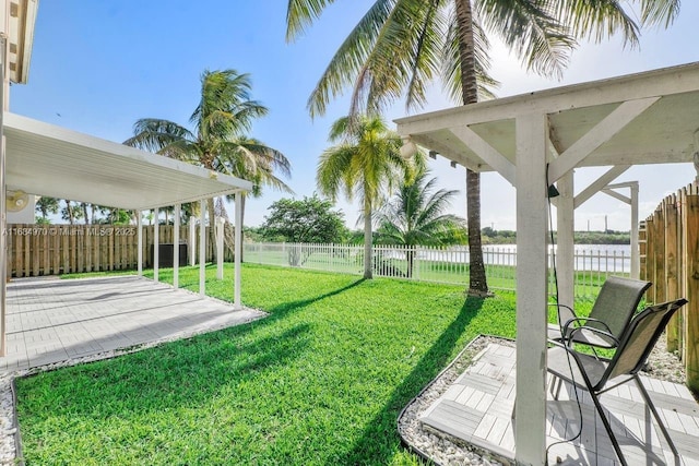 view of yard featuring a patio and a water view