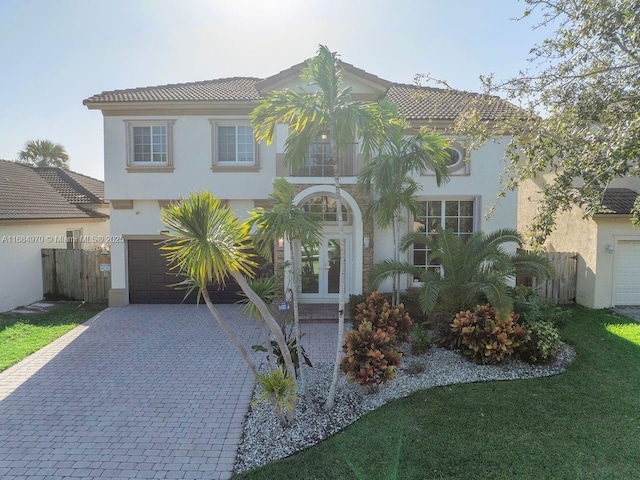 mediterranean / spanish-style house with french doors and a garage