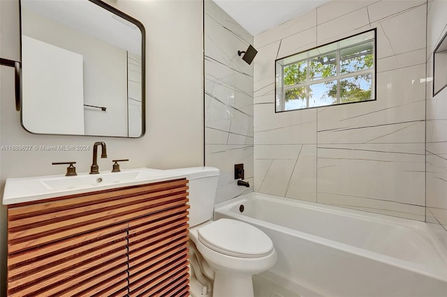 full bathroom with toilet, vanity, and tiled shower / bath