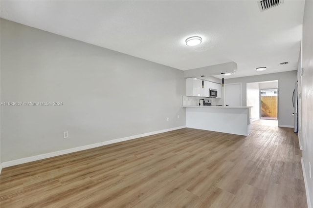 unfurnished living room featuring light wood-type flooring