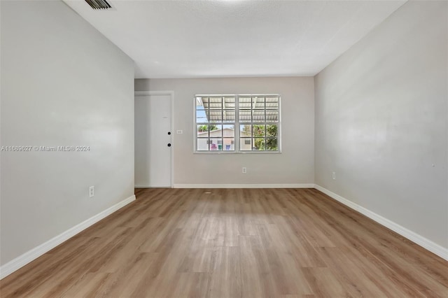 unfurnished room with light hardwood / wood-style floors