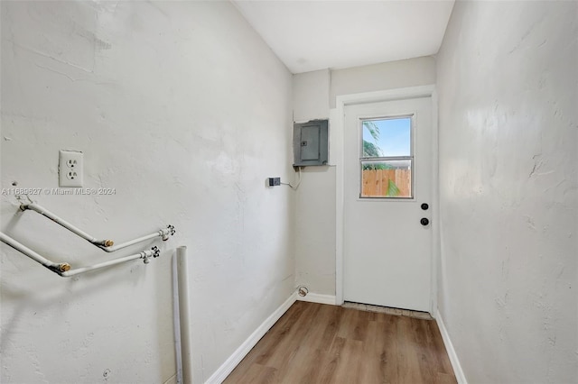 entryway with electric panel and wood-type flooring