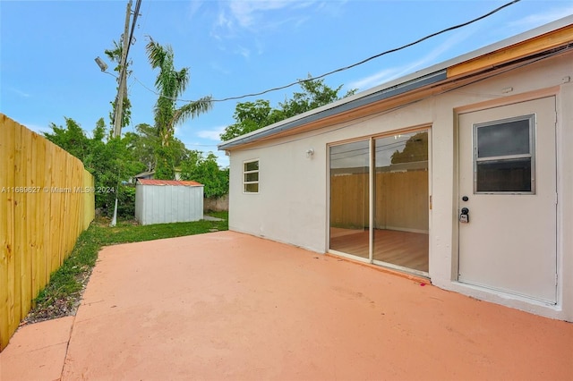 view of patio featuring a storage unit