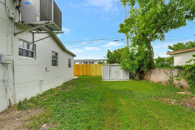 view of yard with a shed and central AC