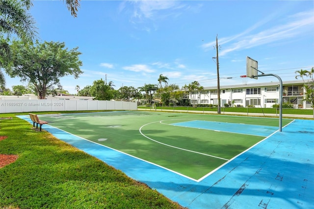 view of basketball court with a lawn