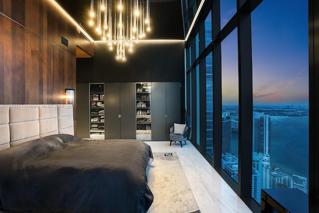 bedroom with a towering ceiling and tile patterned floors