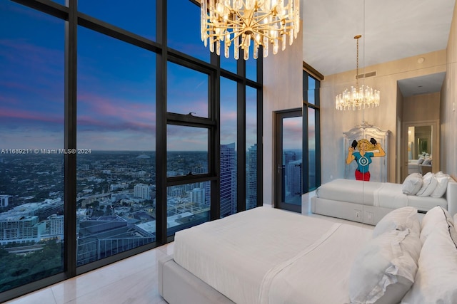 bedroom featuring tile patterned flooring, expansive windows, a high ceiling, and an inviting chandelier