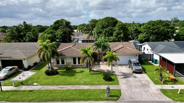 view of front of house with a garage and a front yard