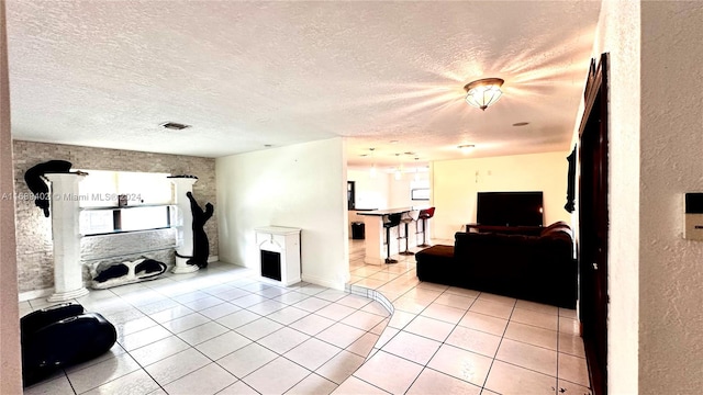 tiled living room with a textured ceiling