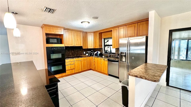 kitchen featuring light tile patterned flooring, black appliances, a textured ceiling, backsplash, and decorative light fixtures